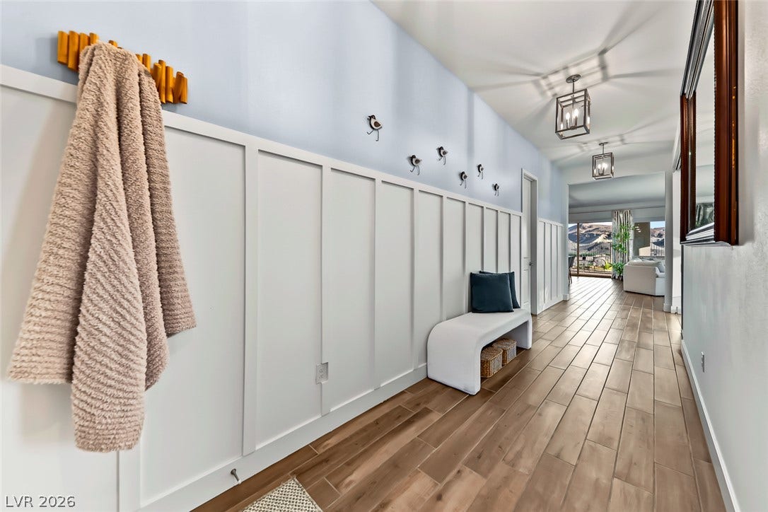 Board and batten paneling details this welcoming entry hall finished with wood-look tile flooring.
