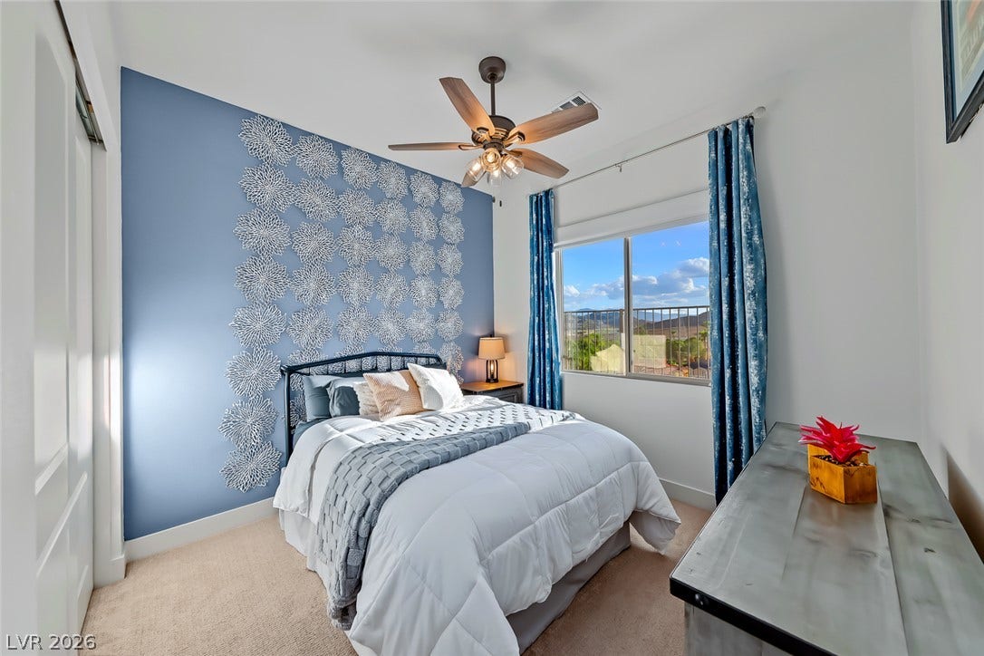 Natural light pours through a large window overlooking scenic neighborhood views.