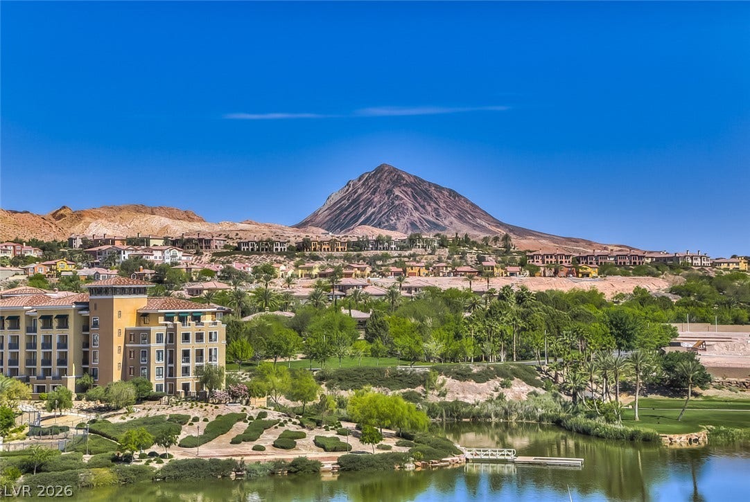 Dramatic mountain vistas rise above the peaceful lake and landscaped shoreline.