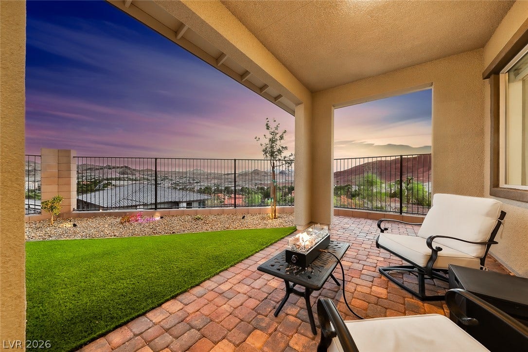 Take in dramatic mountain views from this covered patio surfaced with rich brick pavers.