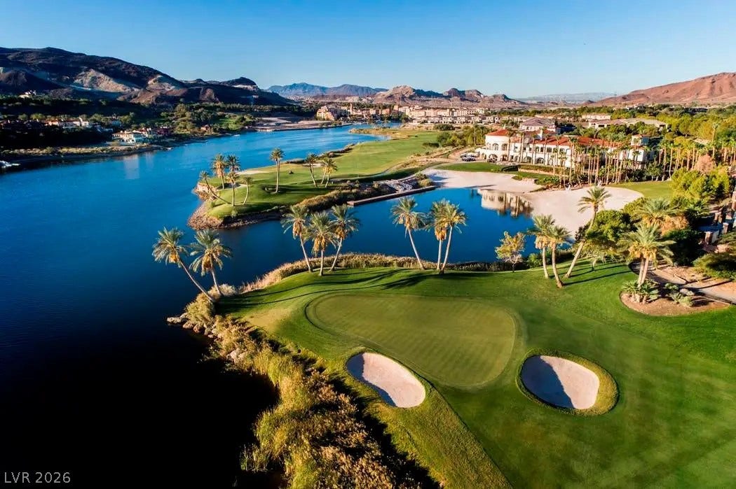 Lush fairways alongside serene water features define this scenic desert community landscape.