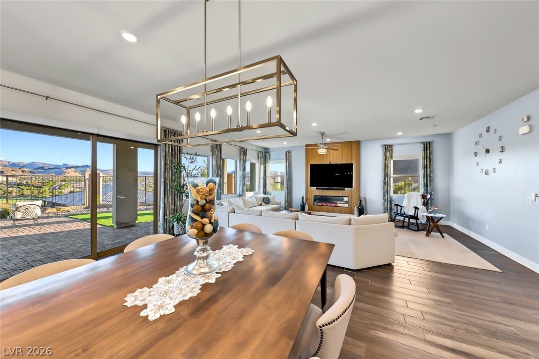 Rich wood flooring runs through this airy dining space into the adjacent living room.