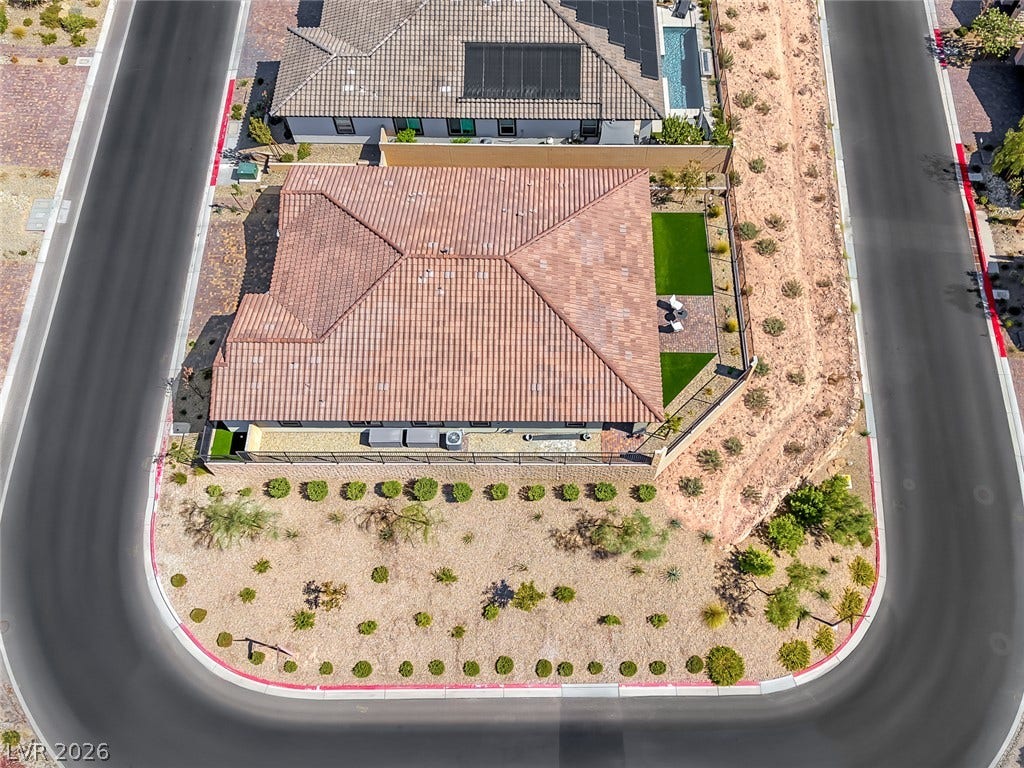 An aerial view showcases the property situated on a unique corner lot.