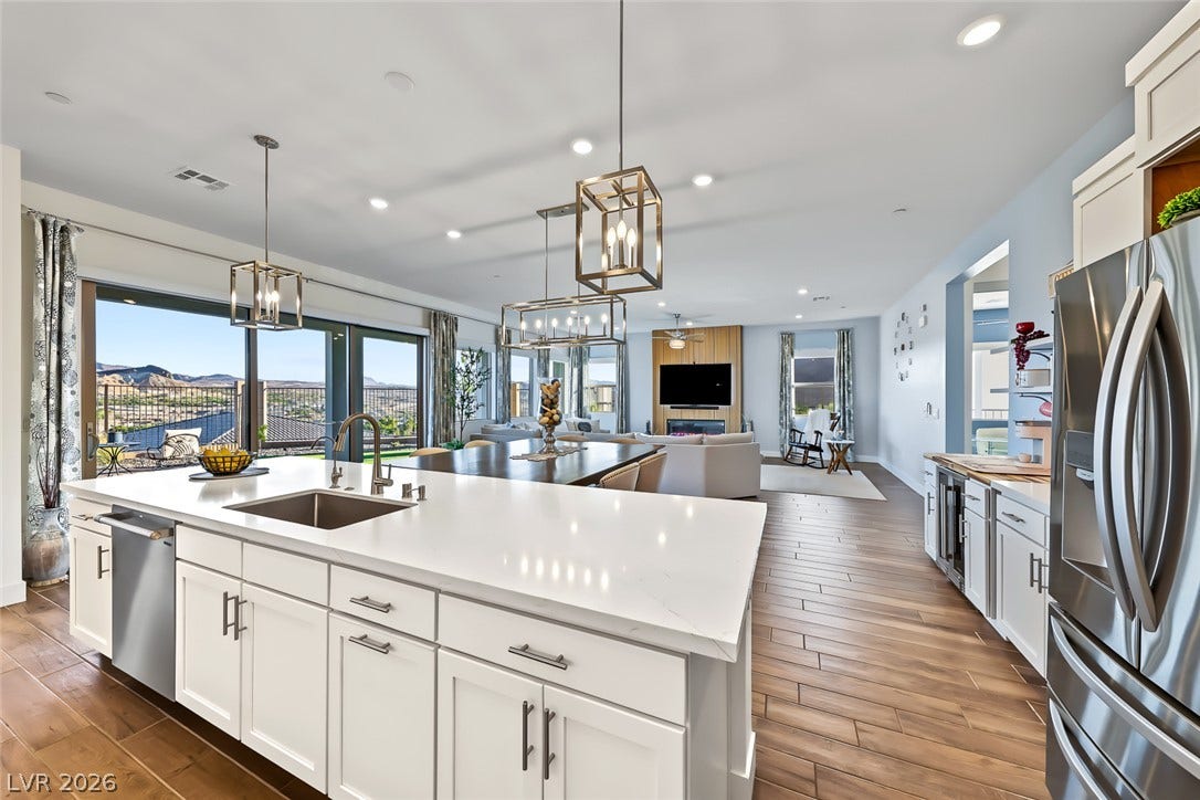 Gleaming stone counters and warm wood floors define this airy open-concept layout.