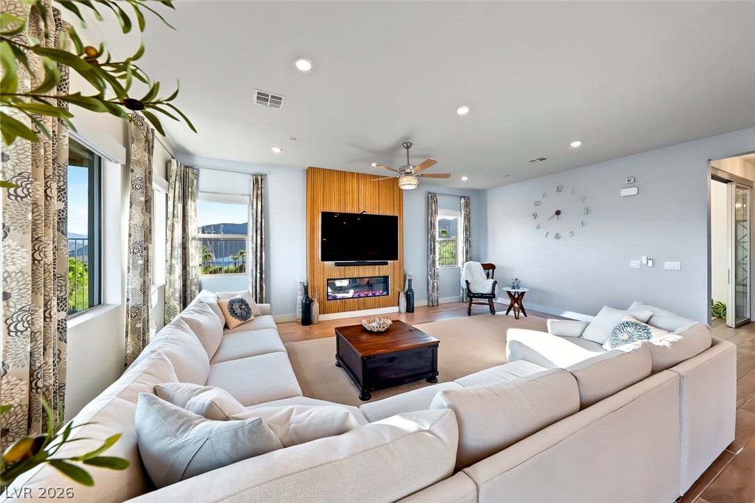 Smooth wood floors and recessed lighting anchor this inviting living space.
