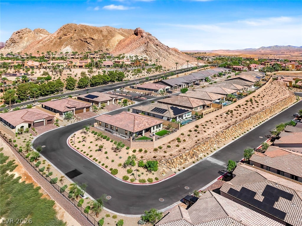 Dramatic mountain backdrops frame this meticulously planned desert community of modern single-story residences.