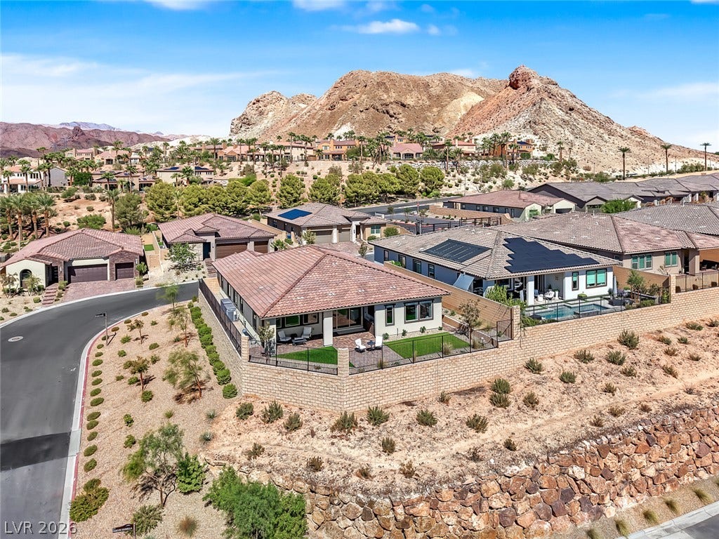 Elevated views showcase the tile roofs and desert mountain backdrop of this neighborhood.