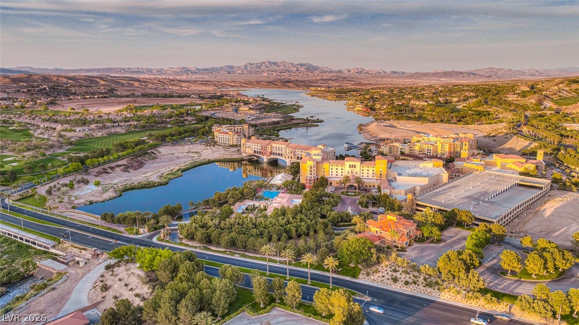 A sweeping panorama captures the lakeside community nestled against a rugged mountain backdrop.