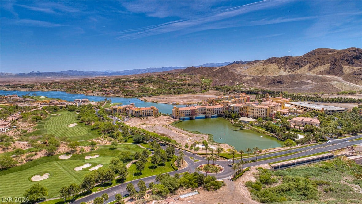 Dramatic mountain vistas frame the sprawling green fairways and sparkling waterways of this desert resort community.