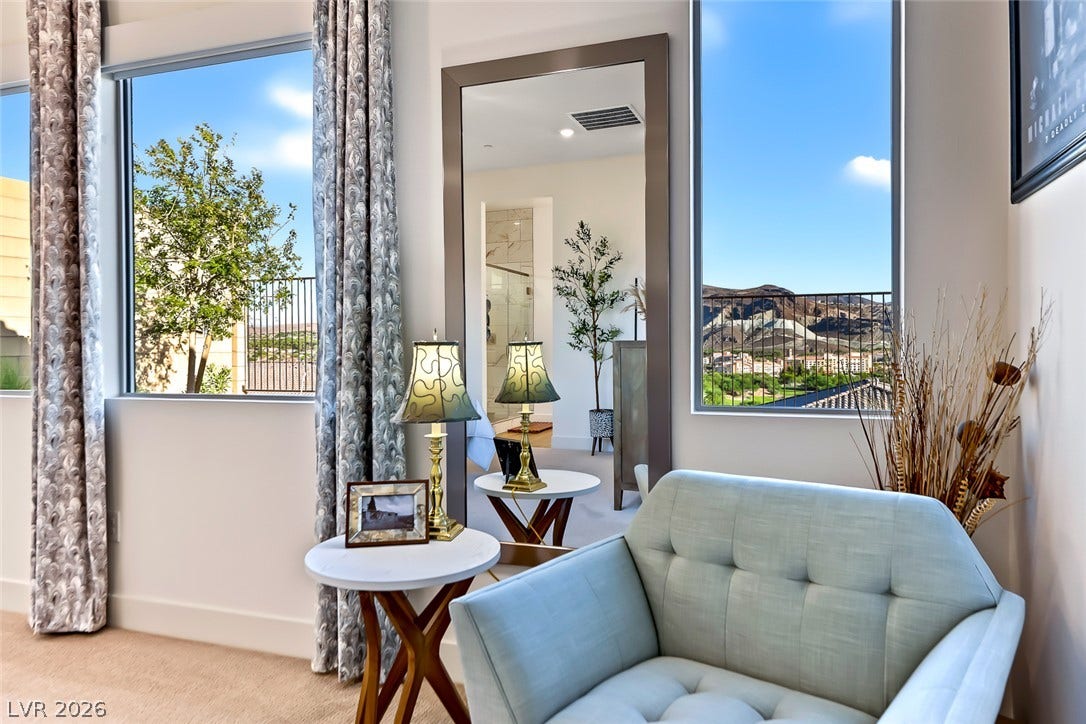 Large windows frame picturesque mountain views from this comfortable sitting area.