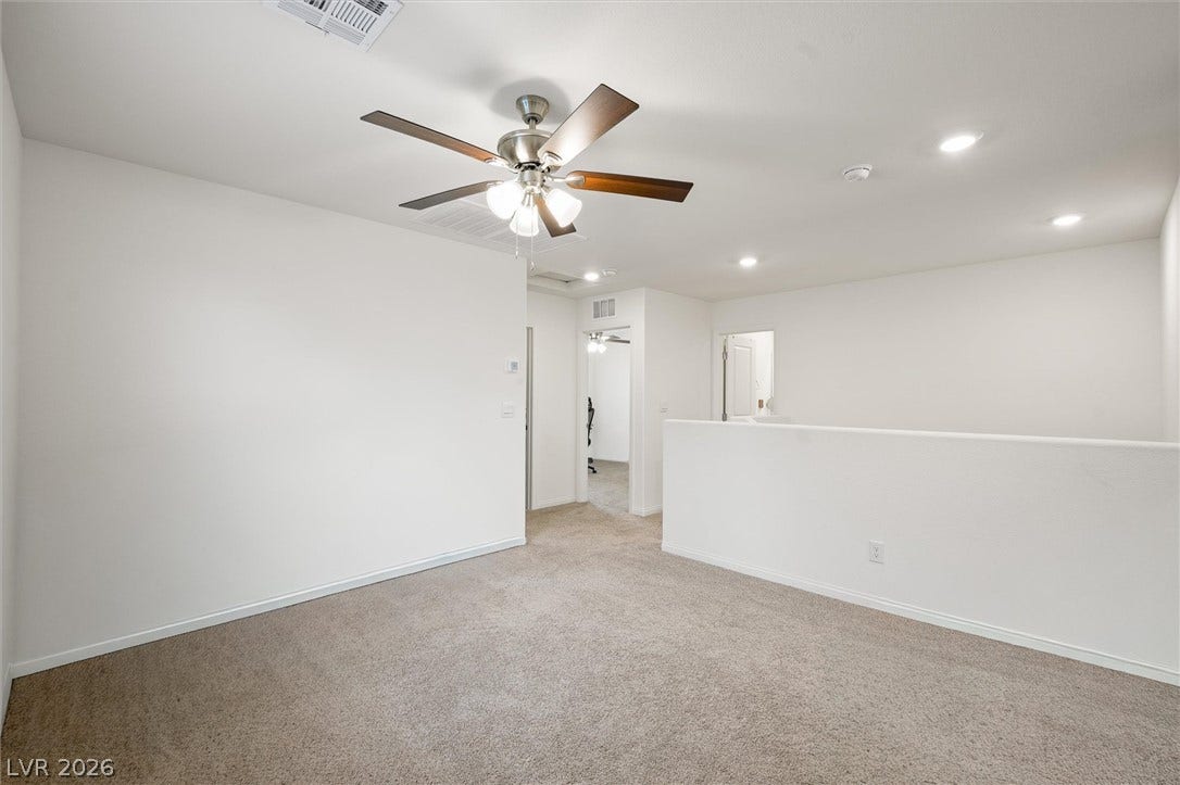 5651 Scarlet Rock Street, North Las Vegas, NV 89081 Plush carpeting and crisp white walls define this versatile upper-level bonus area.