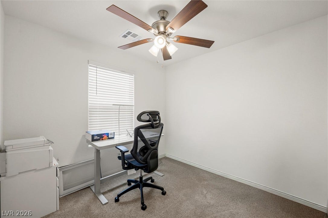 5651 Scarlet Rock Street, North Las Vegas, NV 89081 Plush carpeting and natural light define this versatile room, offering a quiet workspace.