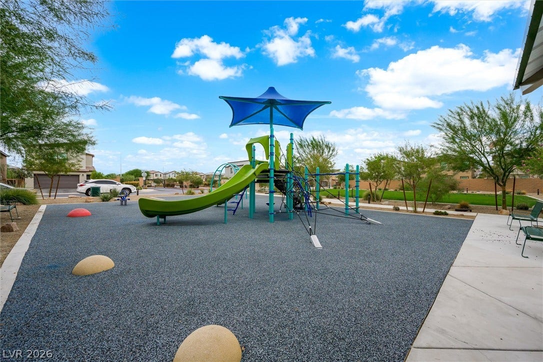5651 Scarlet Rock Street, North Las Vegas, NV 89081 An inviting community playground features safety surfacing under a sunny, open sky.