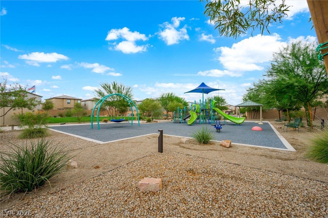 5651 Scarlet Rock Street, North Las Vegas, NV 89081 A modern community park features a vibrant playground set against desert landscaping and clear skies.
