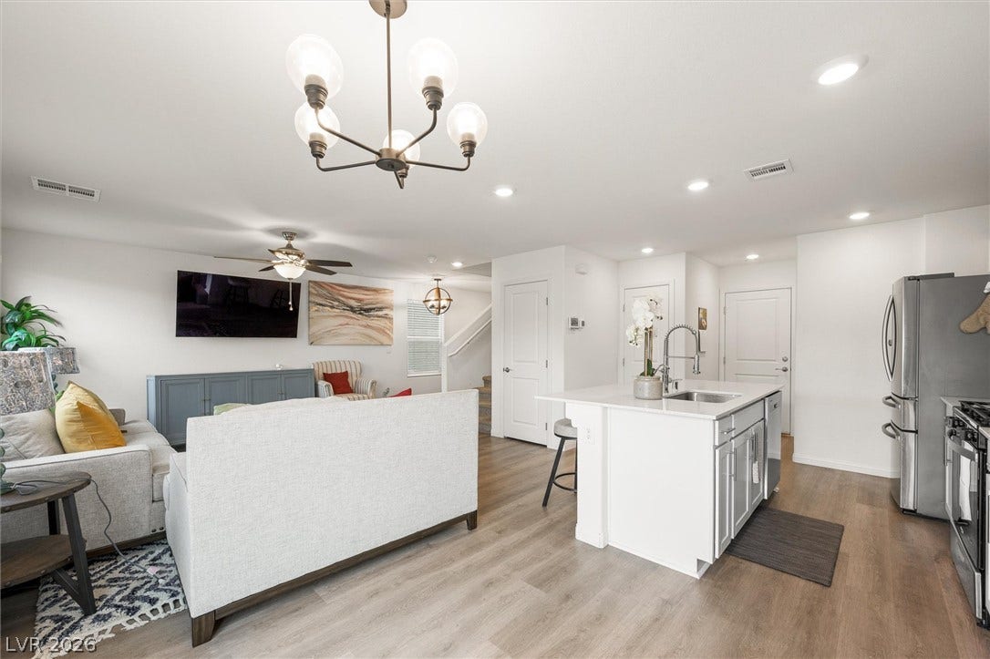 5651 Scarlet Rock Street, North Las Vegas, NV 89081 An open floor plan seamlessly connects the kitchen and main living areas over wood-style flooring.