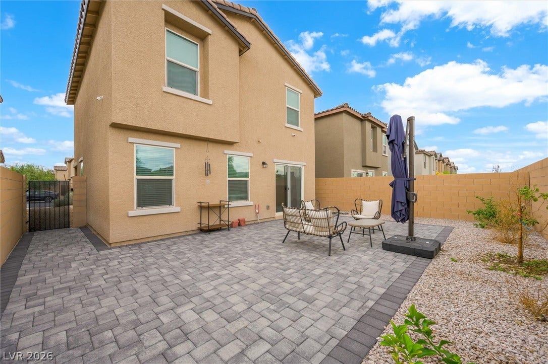 5651 Scarlet Rock Street, North Las Vegas, NV 89081 An inviting backyard patio paved with interlocking stones extends from the stucco exterior.