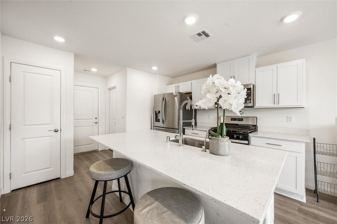 5651 Scarlet Rock Street, North Las Vegas, NV 89081 An open kitchen boasts a central island, recessed lighting, and durable wood-look flooring.