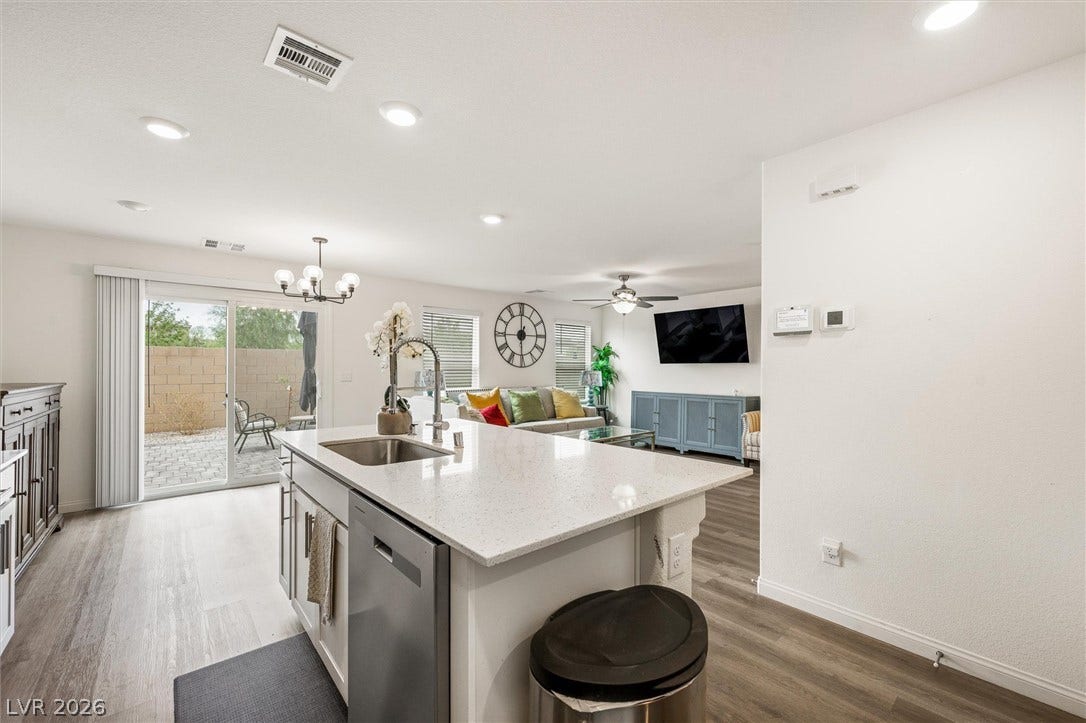 5651 Scarlet Rock Street, North Las Vegas, NV 89081 An open-concept layout connects the kitchen island to the living space through sliding doors.