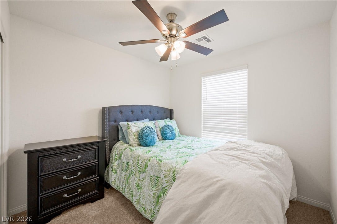 5651 Scarlet Rock Street, North Las Vegas, NV 89081 Soft carpeting pairs with neat trim and a large window in this inviting bedroom.
