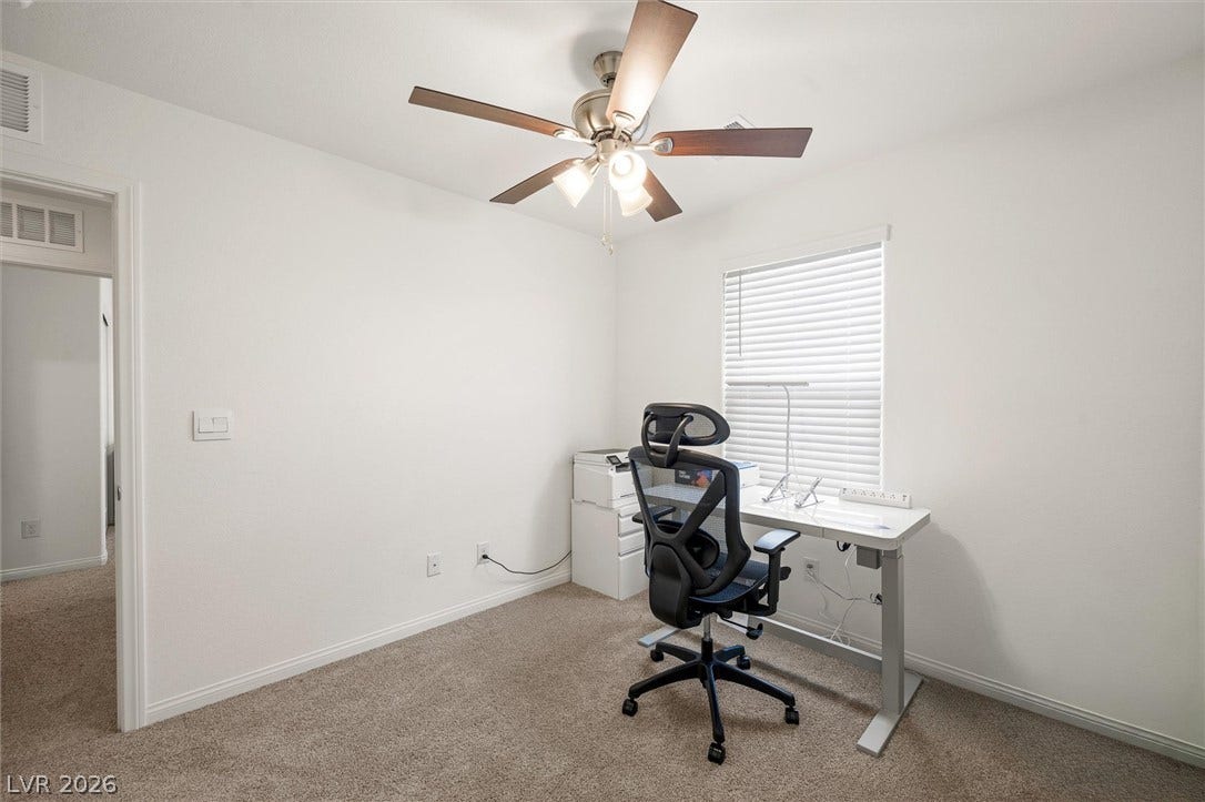 5651 Scarlet Rock Street, North Las Vegas, NV 89081 Crisp walls and plush carpeting define this versatile workspace illuminated by natural light.