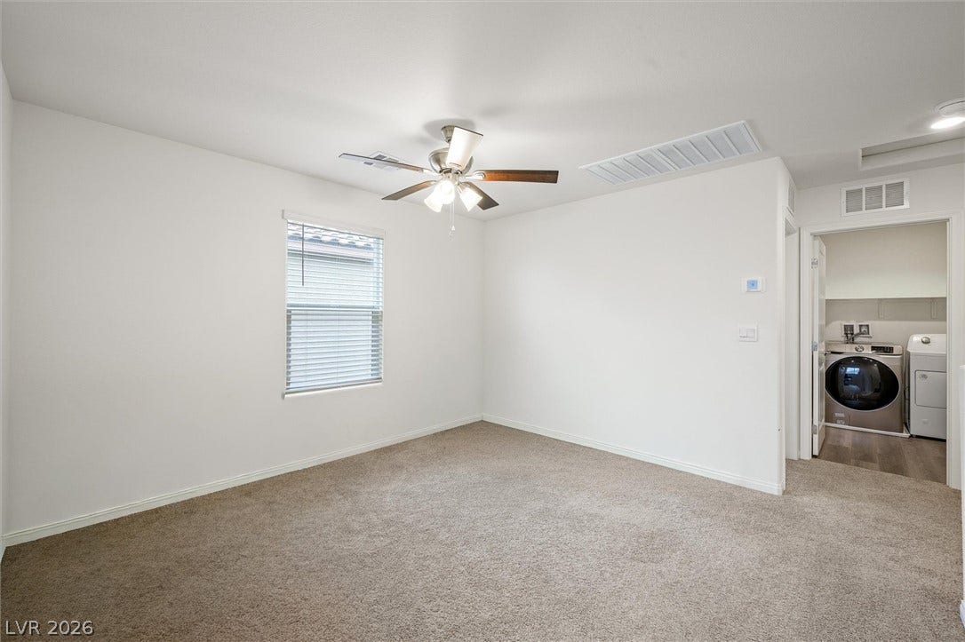 5651 Scarlet Rock Street, North Las Vegas, NV 89081 Plush carpeting and crisp neutral walls define this versatile upper-level space.