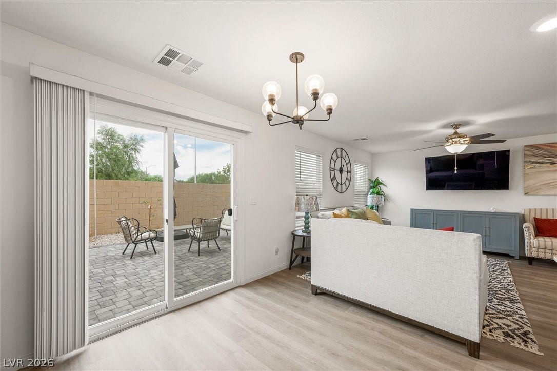 5651 Scarlet Rock Street, North Las Vegas, NV 89081 Sliding glass doors connect the light-filled living area directly to the paved patio.