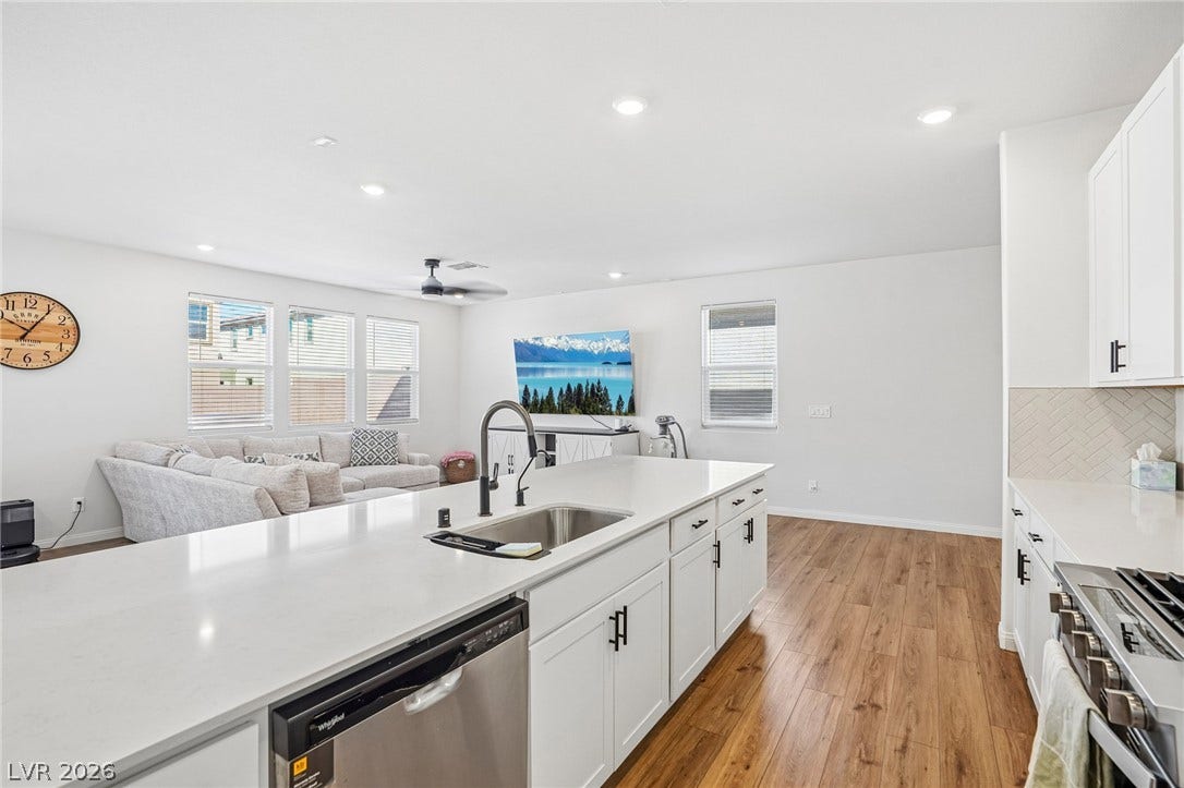 5937 Violet Crown Street, North Las Vegas, NV 89081 Rich wood flooring anchors this open kitchen layout seamlessly connecting to the adjacent living space.