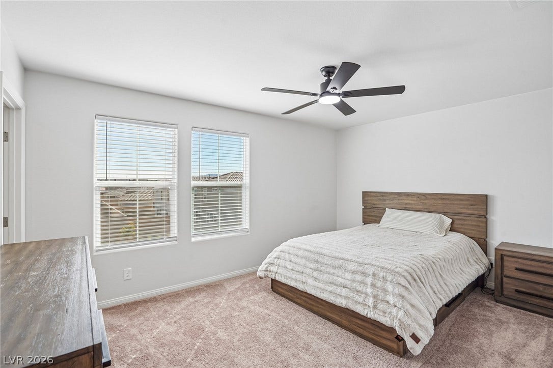 5937 Violet Crown Street, North Las Vegas, NV 89081 Plentiful natural light streams through dual windows, highlighting the clean lines of this modern bedroom.
