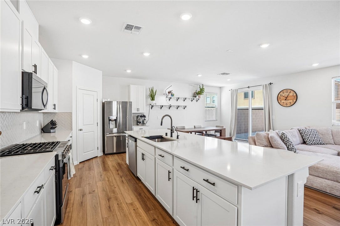 5937 Violet Crown Street, North Las Vegas, NV 89081 An open kitchen boasts a large central island alongside beautiful hardwood flooring and recessed lighting.