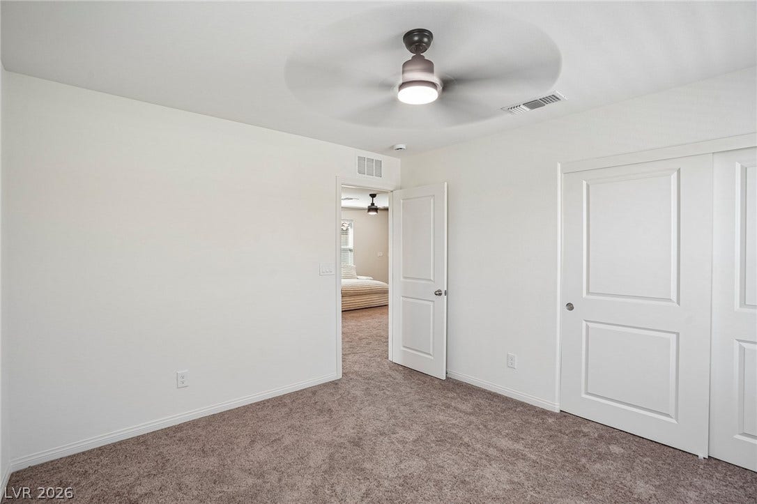 5937 Violet Crown Street, North Las Vegas, NV 89081 Plush carpet flooring and clean white walls establish a serene, private retreat.