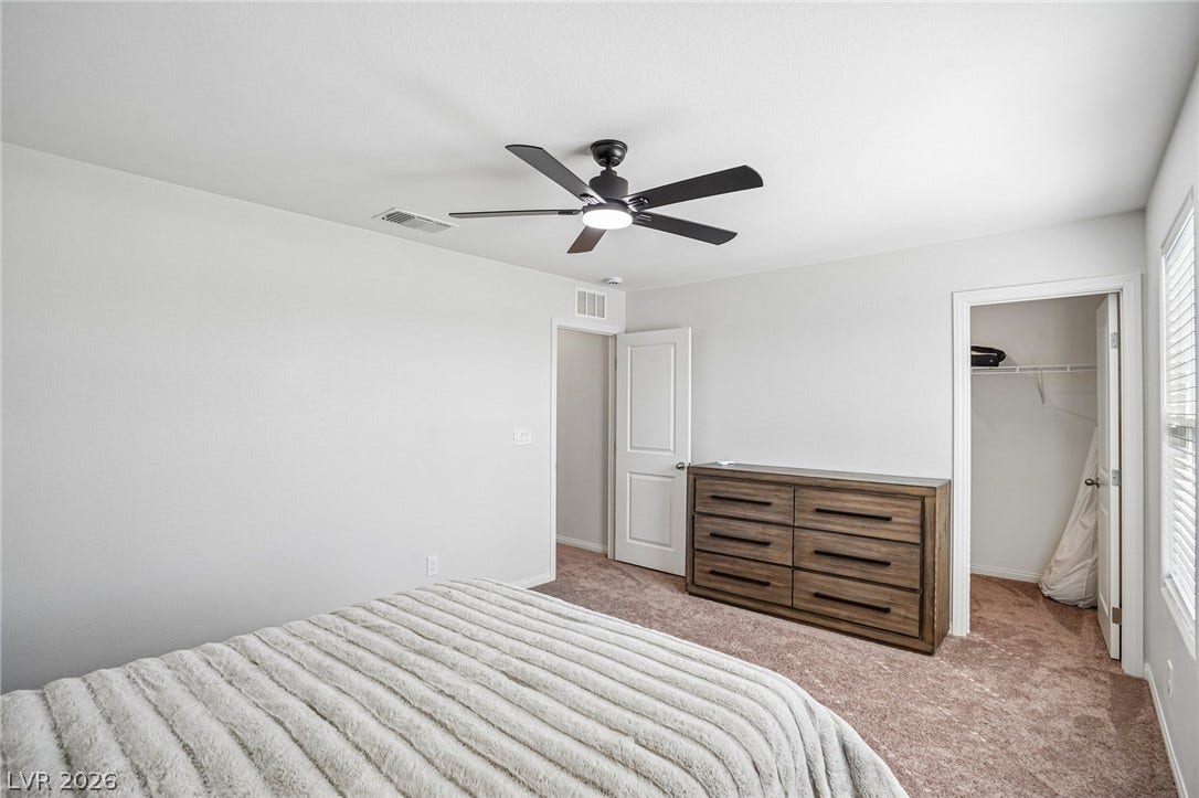 5937 Violet Crown Street, North Las Vegas, NV 89081 A spacious bedroom features neutral walls and plush carpeting.