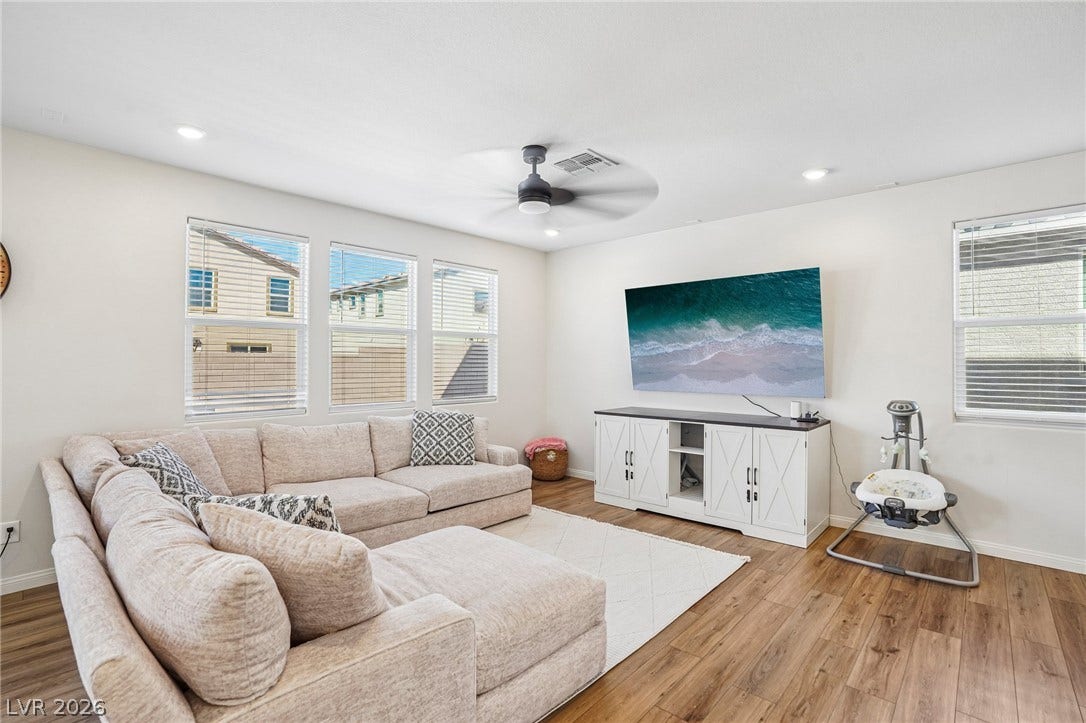 5937 Violet Crown Street, North Las Vegas, NV 89081 Warm wood-look flooring and recessed lighting define this comfortable, light-filled gathering space.