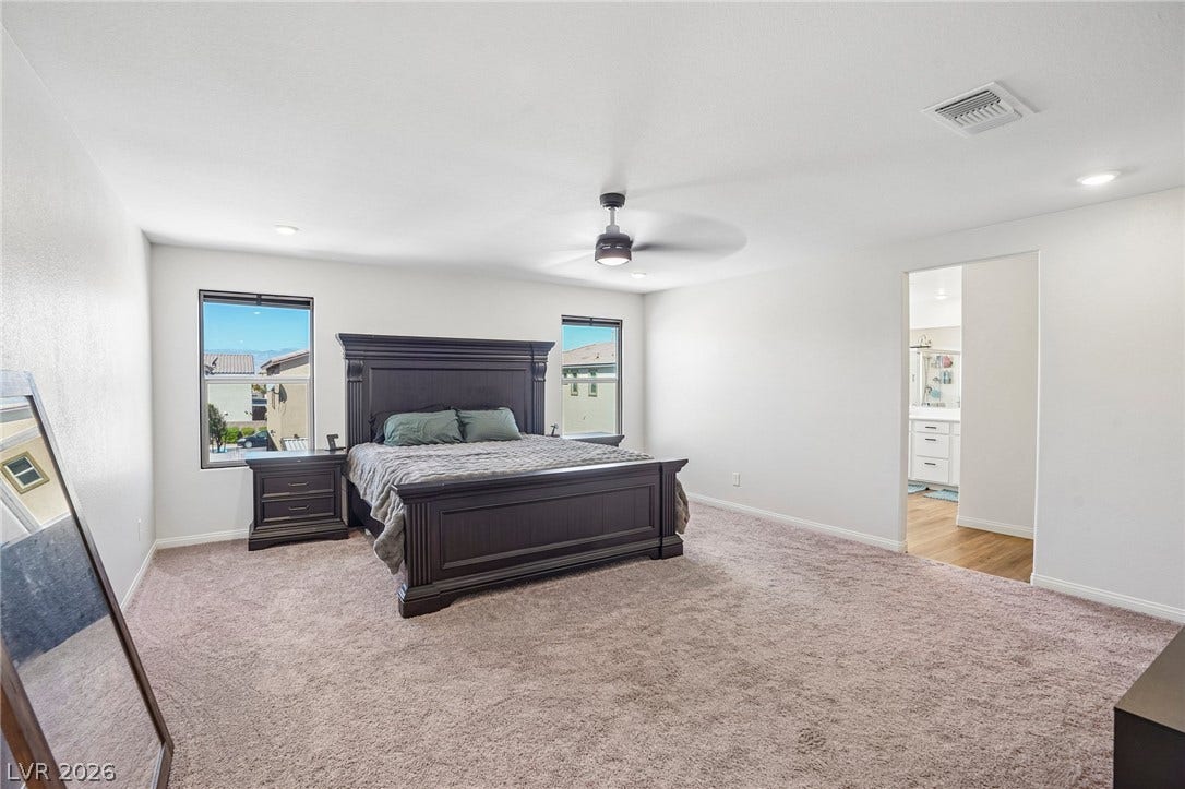 5937 Violet Crown Street, North Las Vegas, NV 89081 Generous proportions highlight this comfortable main suite offering thick carpeting and dual windows.