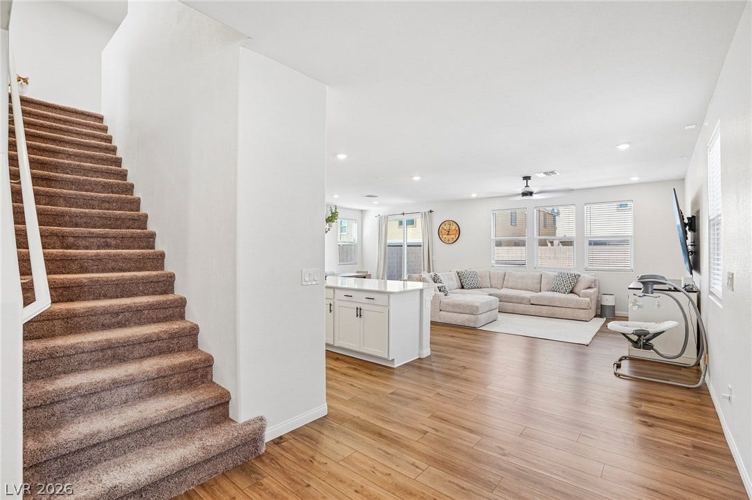 5937 Violet Crown Street, North Las Vegas, NV 89081 Clean lines and smooth flooring define this light-filled, open-concept living area with adjacent kitchen island.