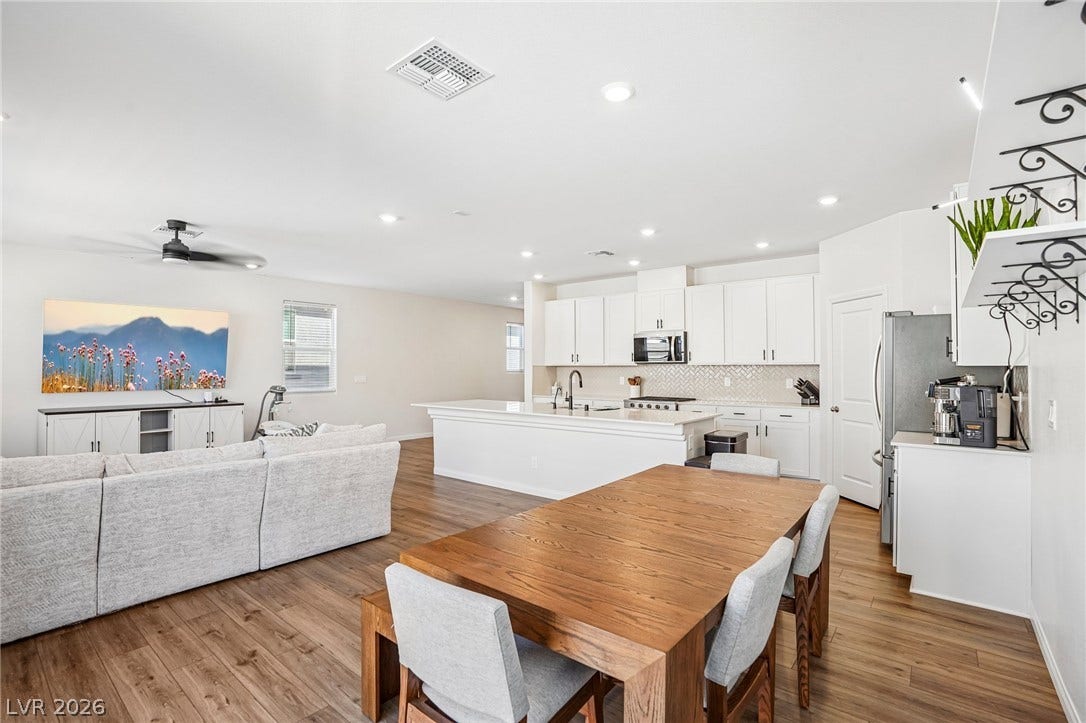 5937 Violet Crown Street, North Las Vegas, NV 89081 Rich wood flooring anchors this sprawling open-concept living area and adjacent kitchen.