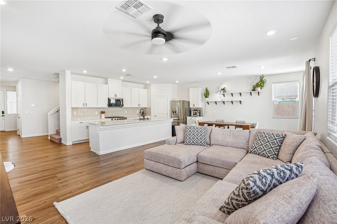 5937 Violet Crown Street, North Las Vegas, NV 89081 Gleaming hardwood floors and a spacious kitchen anchor this expansive open-concept living area.