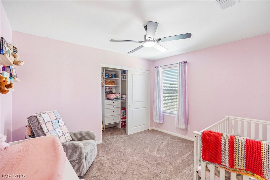 5937 Violet Crown Street, North Las Vegas, NV 89081 Plush carpeting and a built-in closet system anchor this comfortable bedroom.