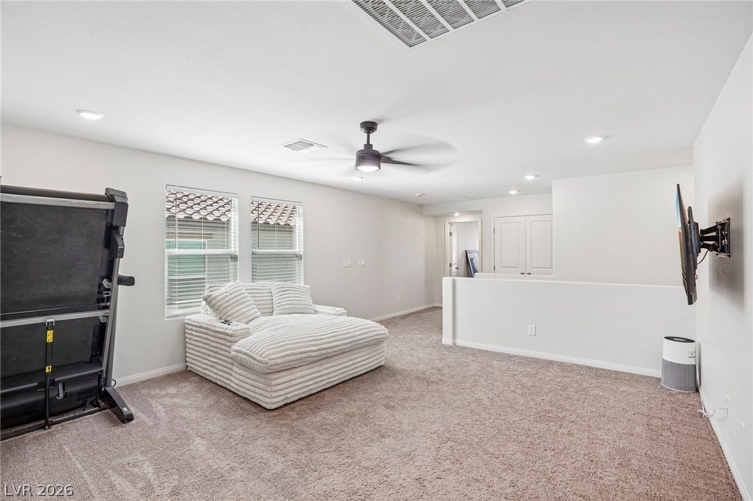 5937 Violet Crown Street, North Las Vegas, NV 89081 Plush wall-to-wall carpeting and clean neutral walls anchor this versatile upstairs loft space.