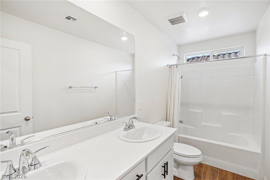 5937 Violet Crown Street, North Las Vegas, NV 89081 Crisp finishes and a dual vanity define this functional washroom.