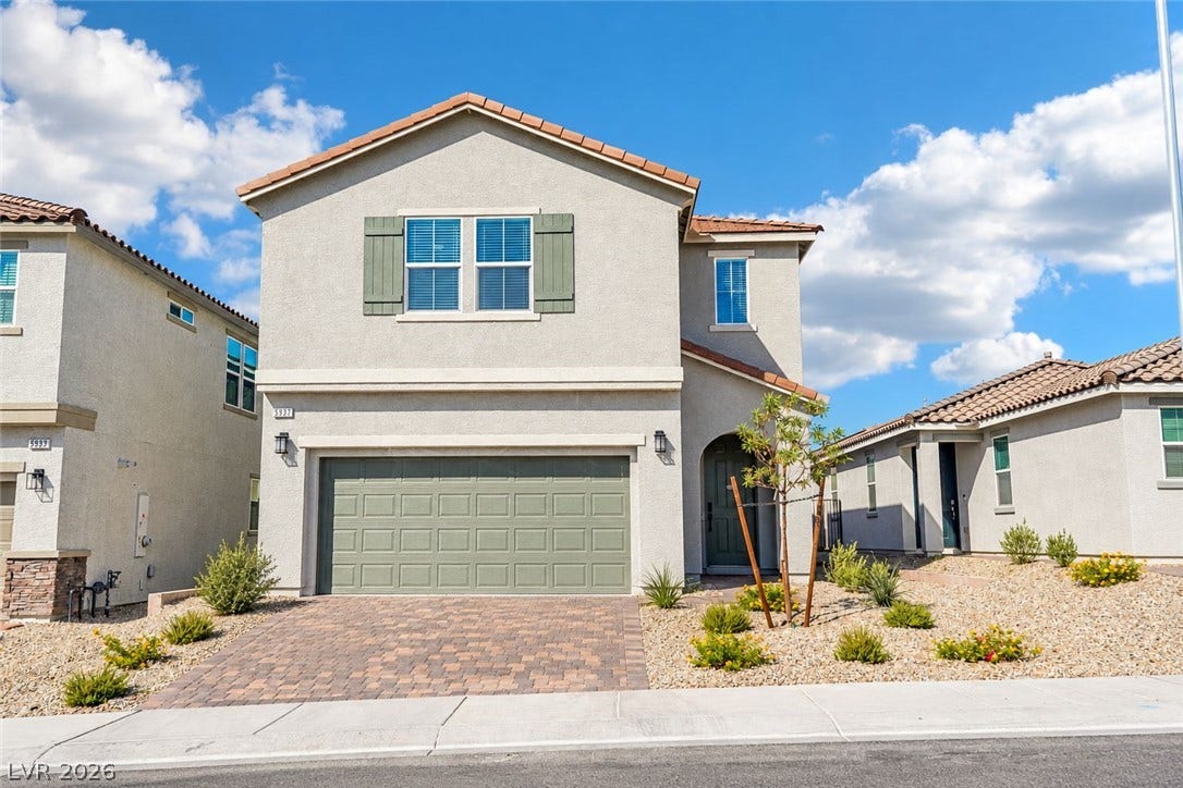 5937 Violet Crown Street, North Las Vegas, NV 89081 A classic stucco exterior features a tiled roof and an elegant paver driveway.