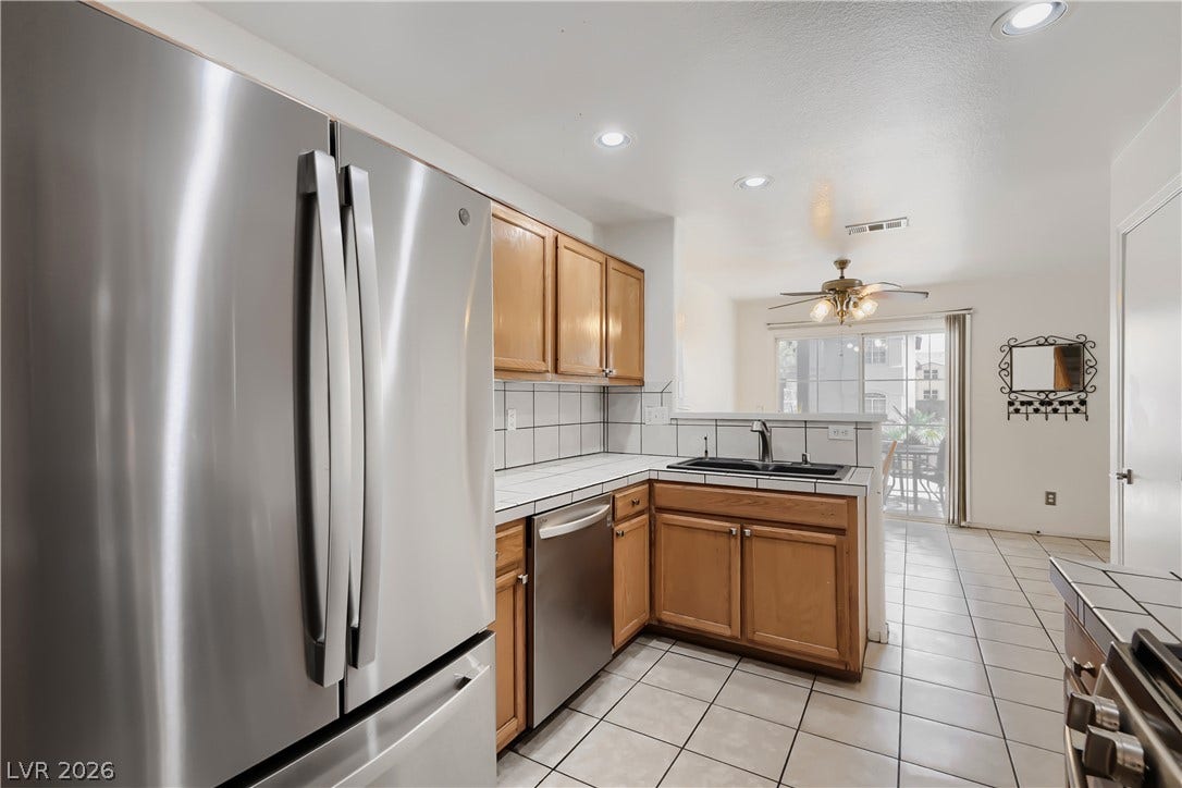 Tiled flooring extends from the functional kitchen layout into the adjacent dining area.