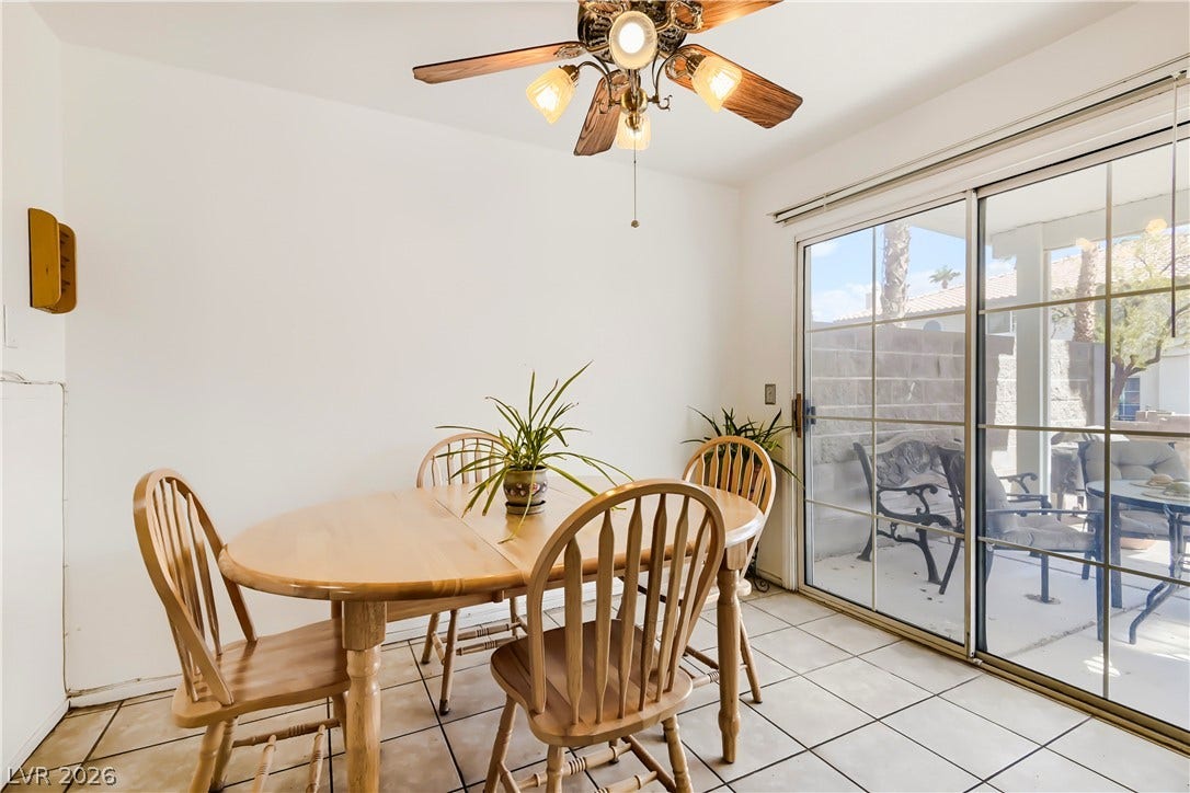 Sliding glass doors open from the tiled dining area to a sunny back patio.