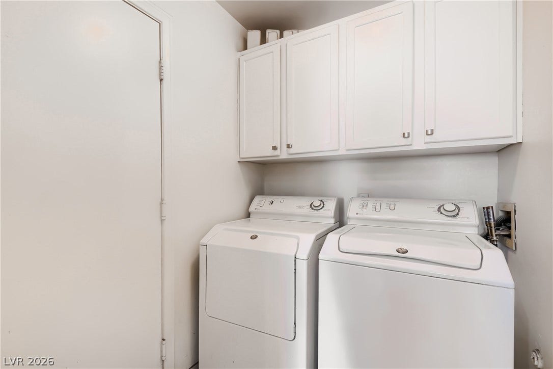 Ample overhead cabinetry maximizes storage potential in this functional utility area.