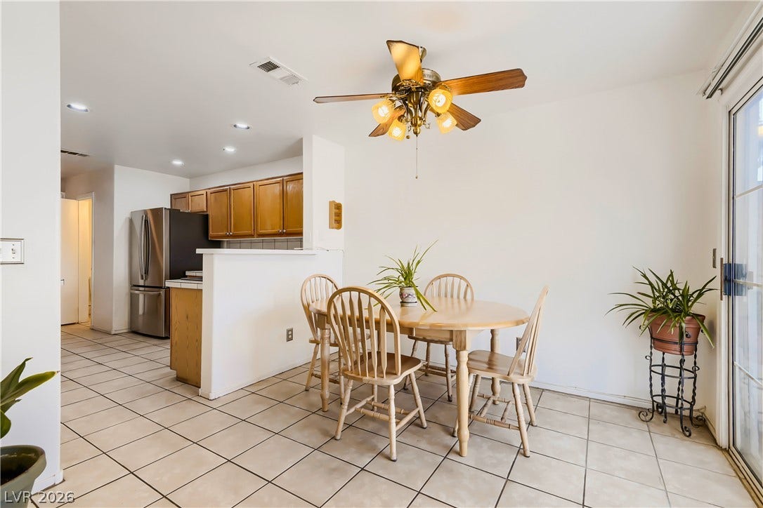 Tiled flooring flows through this dining space adjacent to the kitchen.