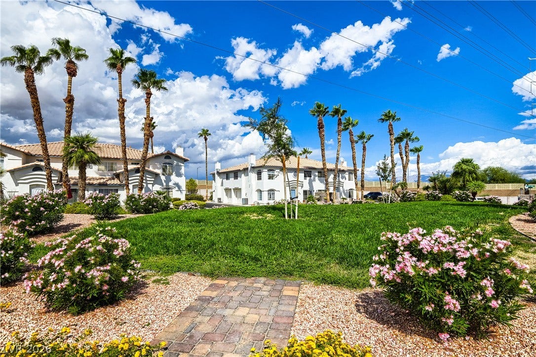 Manicured lawns and swaying palm trees frame the neighborhood views under clear blue skies.