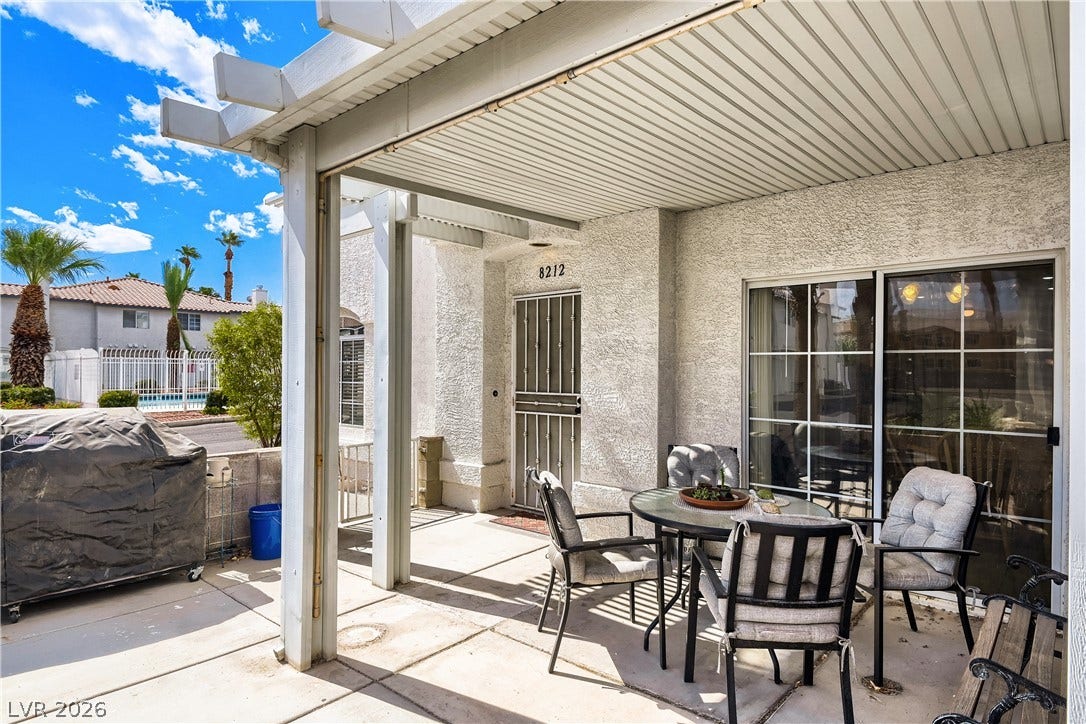 A spacious covered patio provides a shaded outdoor space directly off the main living area.
