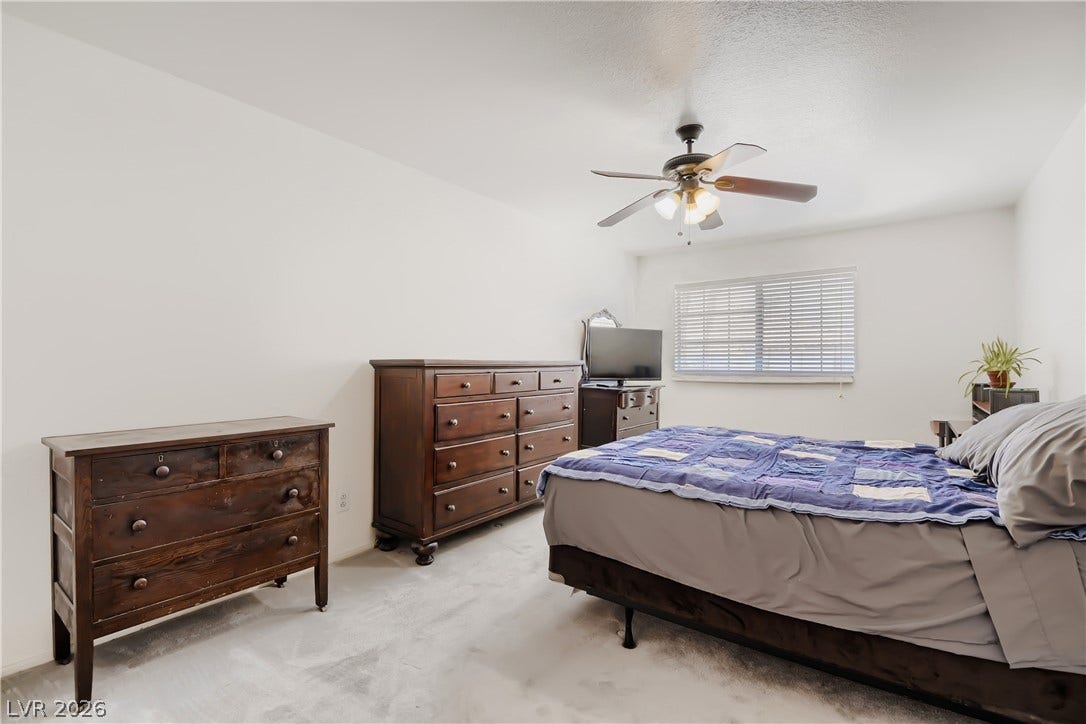 Plentiful wall space and soft neutral carpeting define this comfortable sleeping area.