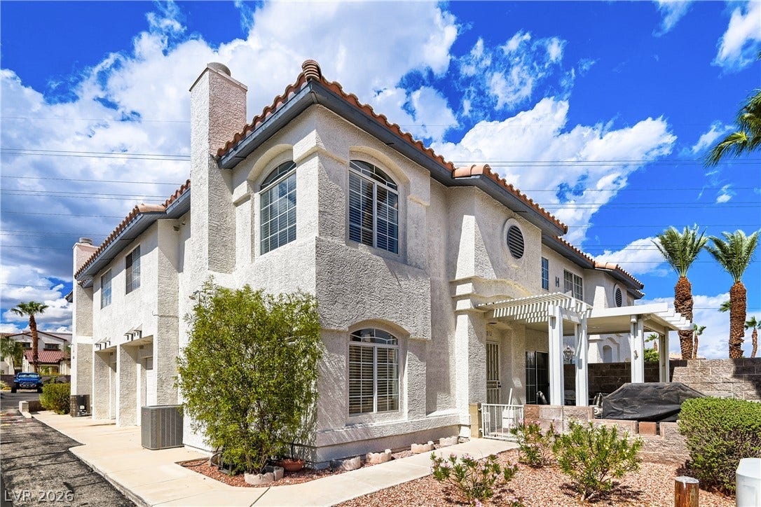 Mediterranean architectural details and an arched window design set against a vibrant blue sky.