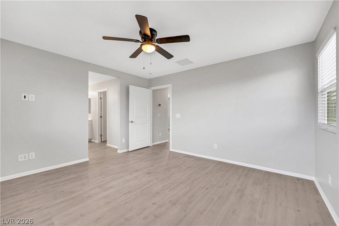 Smooth vinyl plank flooring and multiple windows create a clean, airy feel.