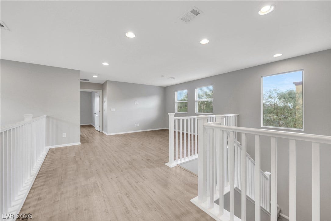 Upstairs Spacious Loft with natural lighting and smooth vinyl plank flooring.